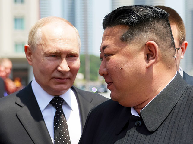 Russian President Vladimir Putin, left, and North Korea's leader Kim Jong Un attend the of