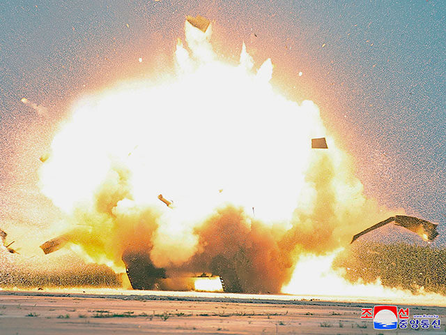 This photo provided by the North Korean government shows an explosion after it says a dron