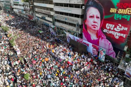 Bangladesh Nationalist Party activists gather in front of a poster of Khaleda Zia, during