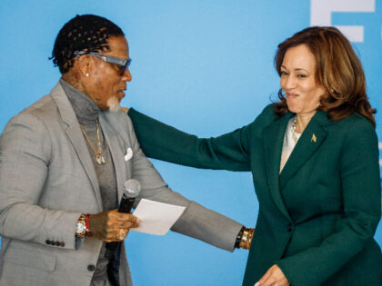 US Vice President Kamala Harris greets radio talk show host and author DL Hughley as she a