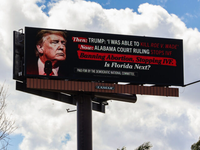 MIAMI, FLORIDA - FEBRUARY 27: A billboard sponsored by the The Democratic National Committ