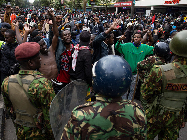 Protesters march while chanting anti-government slogans during a demonstration against tax