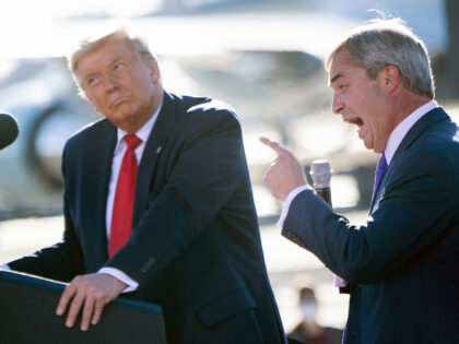 US President Donald Trump listens as Nigel Farage (R) speaks during a Make America Great A