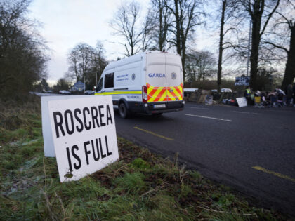 A Garda van passes protesters at the Racket Hall hotel in Roscrea, Co Tipperary demonstrat