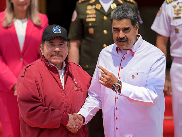 Venezuela's President Nicolas Maduro (R) welcomes Nicaragua's President Daniel Ortega upon