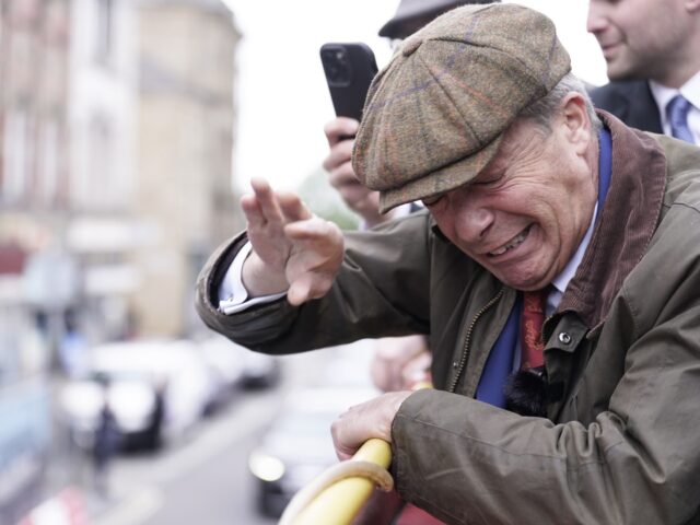 Reform UK leader Nigel Farage reacts after something is thrown towards him on the Reform U