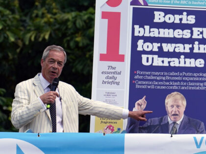 Reform UK leader Nigel Farage speaking on top of a double decker bus at the Mercure Maidst