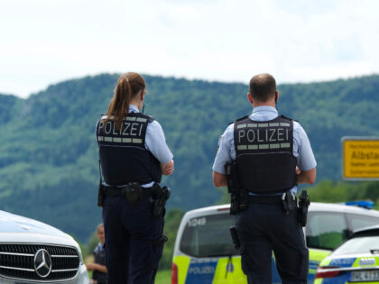 Policemen are seen next to their cars at the site of a crime in Albstadt-Lautlingen near R