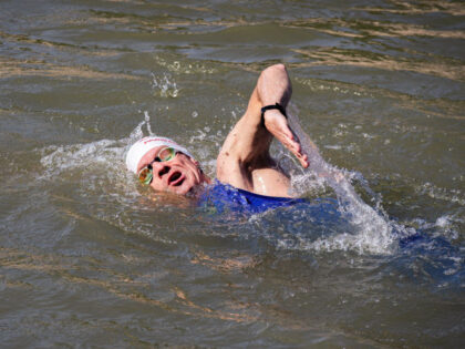 PARIS, FRANCE - 2024/07/17: A man swims in the River Seine as Paris Mayor Anne Hidalgo ful