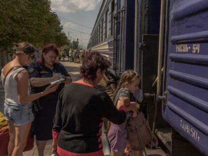 TOPSHOT - Alona, 8 years old, who together with her mother Yulia and brother Oleg evacuate