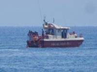 Members of the rescue team placed a body bag onto the lower half of the deck of the fire s