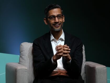 Google boss Sundar Pichai clasps his hands