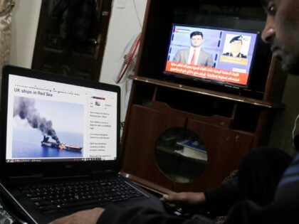 SANA'A, YEMEN - MARCH 4: A man follows news about the recent Houthi attacks on ships, on M