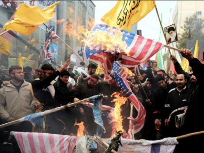 Iranians burn US flags outside the former US embassy in Tehran on November 4, 2013, during