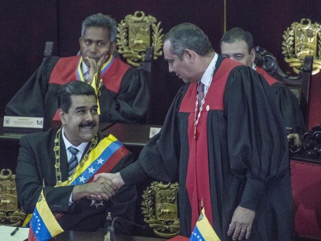 Nicolas Maduro, Venezuela's president, left, shakes hand with Maikel Moreno, Venezuel