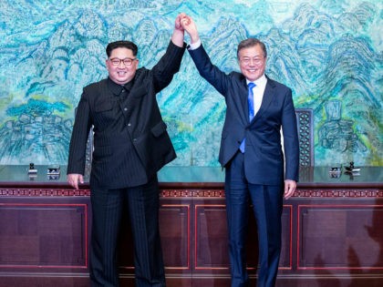 North Korean leader Kim Jong Un, left, and South Korean President Moon Jae-in raise their