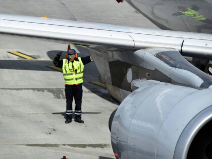 Airport Field Worker at Hamburg Airport before Departure with Airbus A320