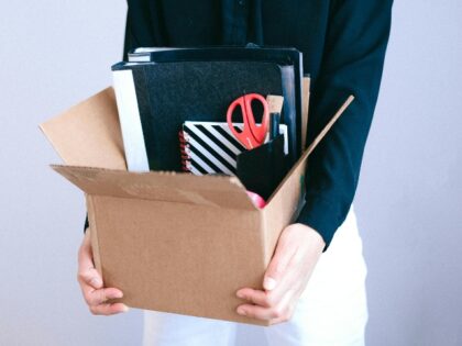 worker carrying belongings after layoff