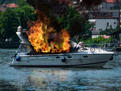 The yacht was engulfed in flames. - stock photo