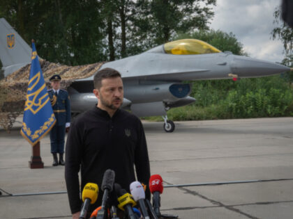 Ukraine's President Volodymyr Zelenskyy answers media questions standing against the backg