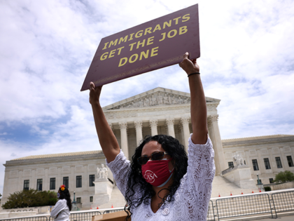 An immigration activist participates in a rally near the U.S. Supreme Court on May 12, 202